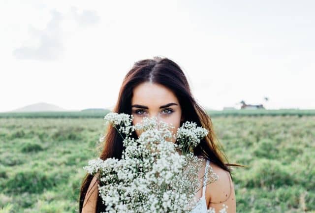 Mladá žena na louce plné květin